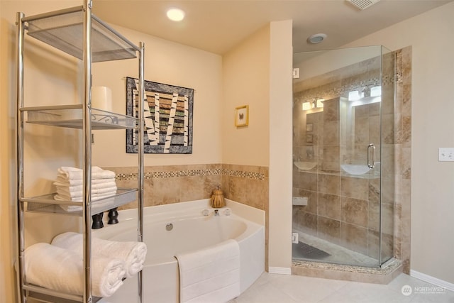 bathroom featuring tile patterned floors and separate shower and tub