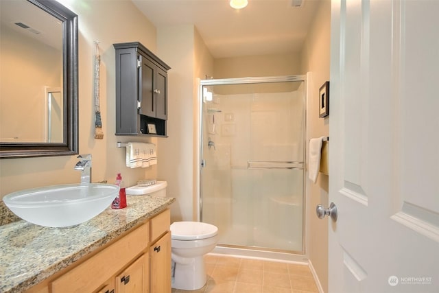 bathroom with vanity, tile patterned flooring, a shower with door, and toilet