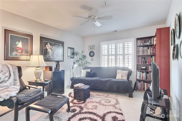 carpeted living room with ceiling fan