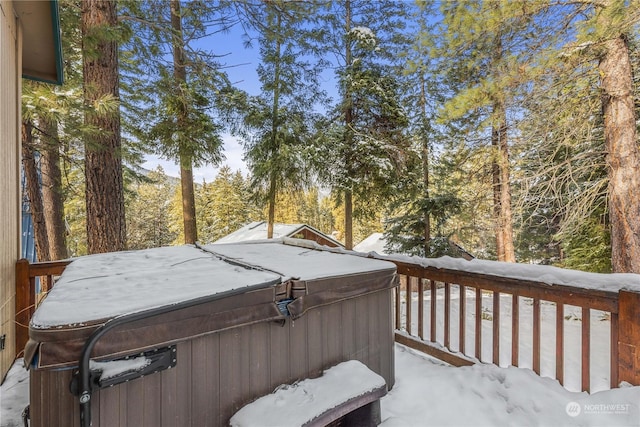 snow covered deck featuring a hot tub