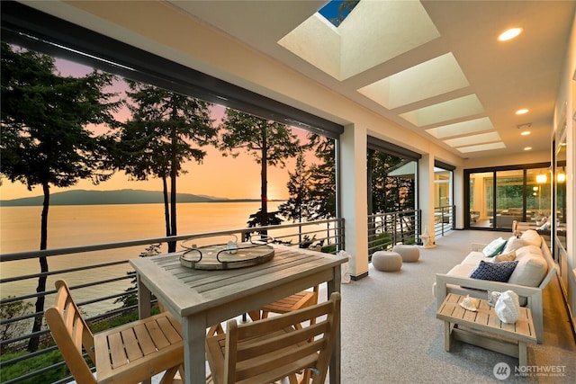 sunroom / solarium with a water view