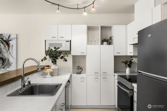 kitchen featuring white cabinetry, sink, and appliances with stainless steel finishes