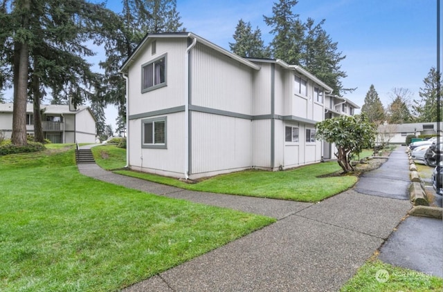 view of property exterior with a yard