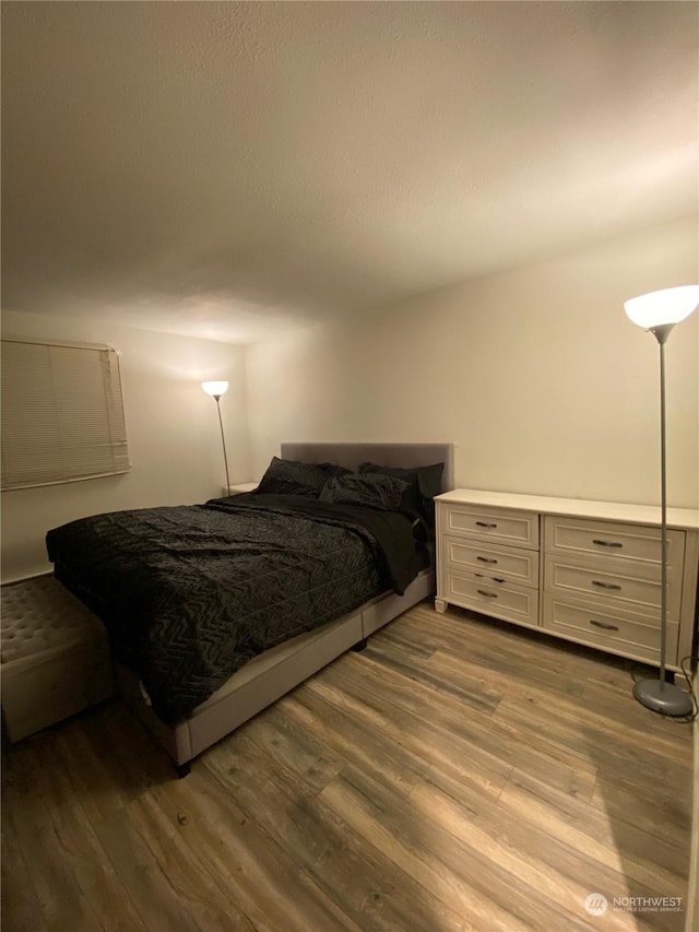 bedroom with hardwood / wood-style floors