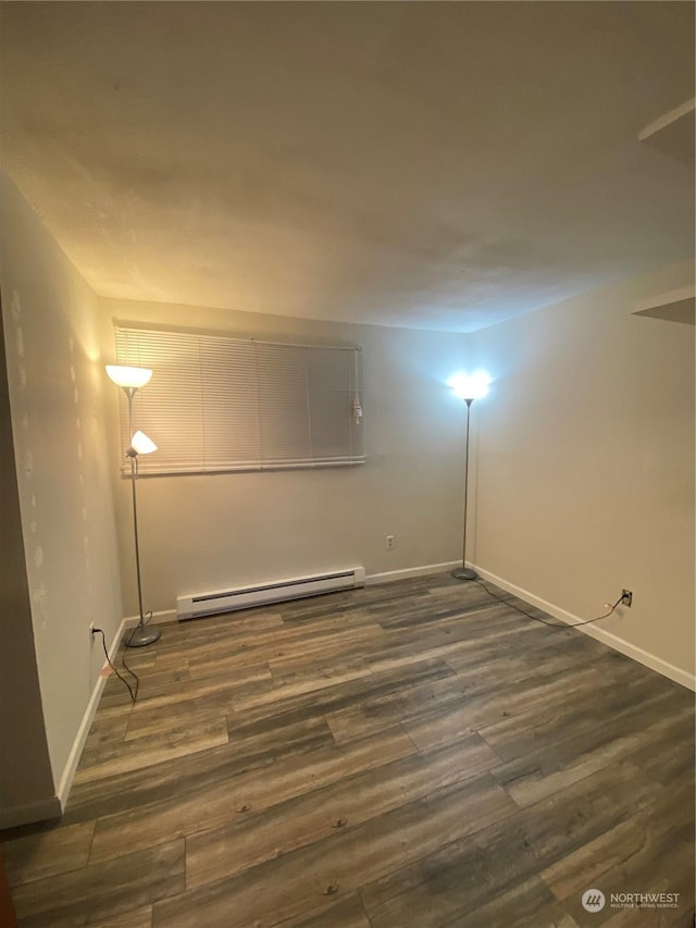 interior space with dark hardwood / wood-style flooring and baseboard heating