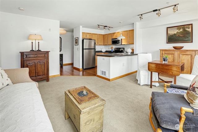 living room with light colored carpet, visible vents, and baseboards