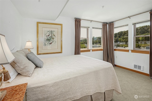 carpeted bedroom with visible vents and baseboards