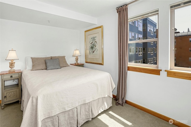 bedroom with light carpet and baseboards