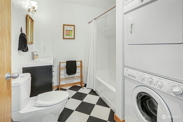 bathroom with shower / tub combo, toilet, stacked washer / drying machine, tile patterned floors, and vanity