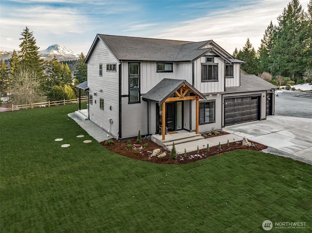 modern farmhouse style home with a garage, a mountain view, and a front yard