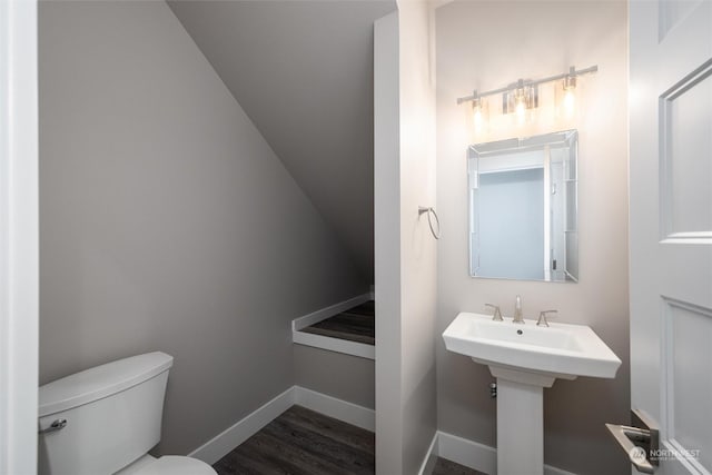 bathroom featuring wood-type flooring and toilet