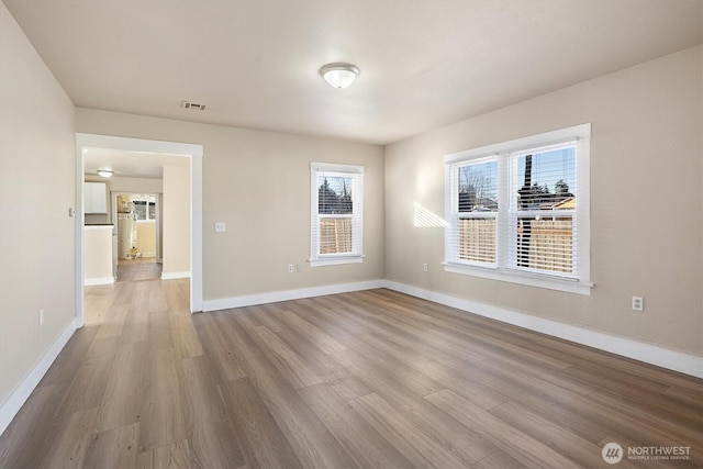 unfurnished room with hardwood / wood-style flooring