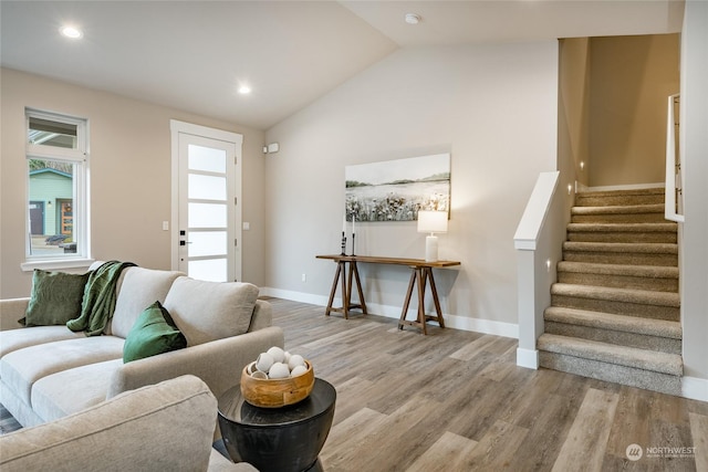 living room with lofted ceiling and light hardwood / wood-style flooring