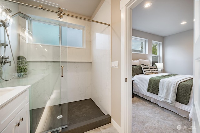 bathroom with vanity and a shower with shower door