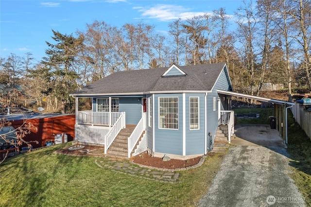 view of outdoor structure featuring a yard, a carport, and a porch