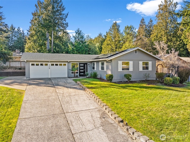 single story home featuring a garage, a front yard, and solar panels