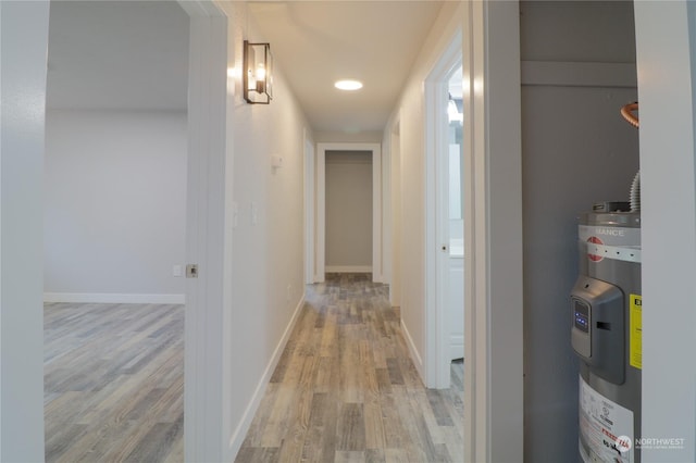 corridor featuring light hardwood / wood-style floors and water heater