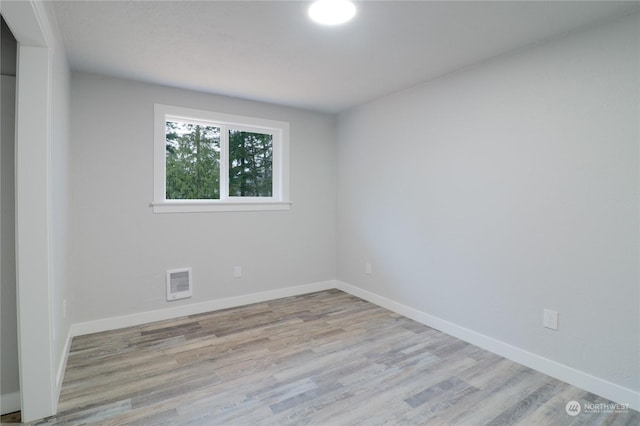 unfurnished room with light hardwood / wood-style floors