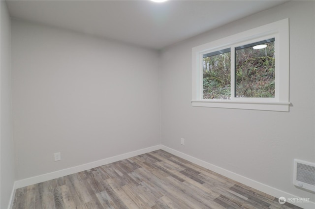 spare room featuring light hardwood / wood-style floors