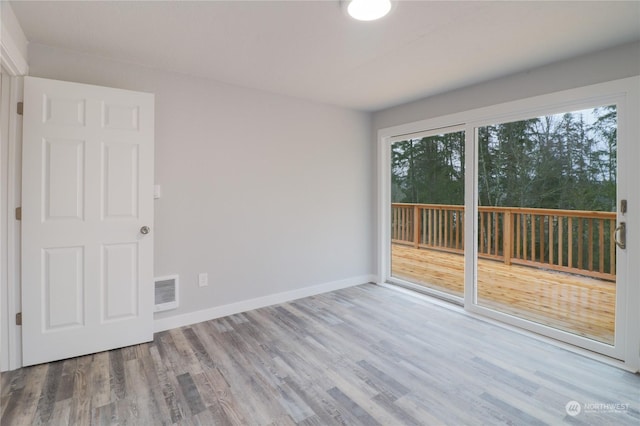 unfurnished room with light hardwood / wood-style flooring