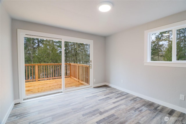 empty room with light hardwood / wood-style flooring