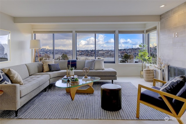 carpeted living room with a tiled fireplace