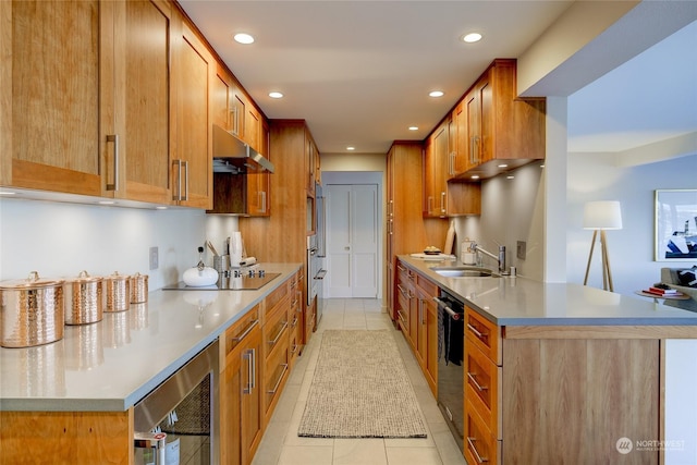 kitchen with wine cooler, sink, light tile patterned floors, and black appliances