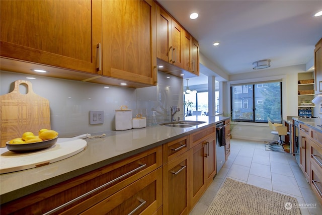 kitchen with tasteful backsplash, light tile patterned flooring, dishwasher, and sink