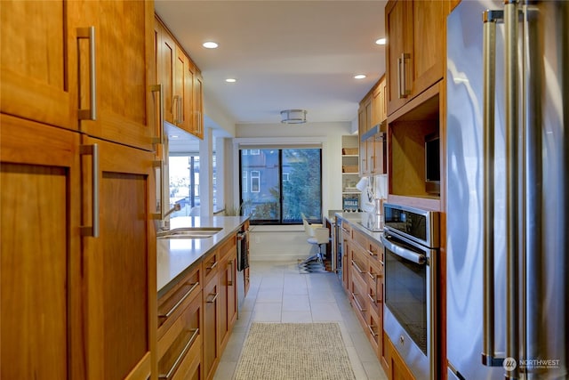 kitchen featuring sink, light tile patterned floors, and appliances with stainless steel finishes