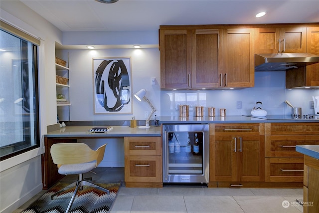 kitchen with wine cooler, black electric stovetop, light tile patterned flooring, and built in desk