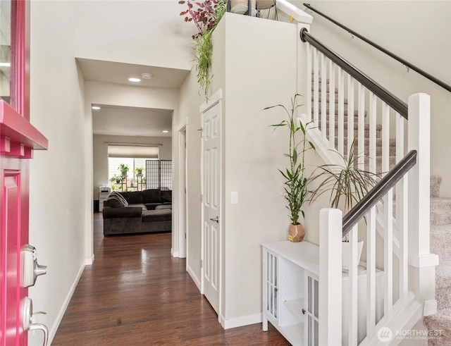 foyer with stairway, baseboards, and wood finished floors