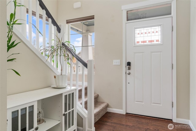 entrance foyer with stairway, baseboards, and wood finished floors