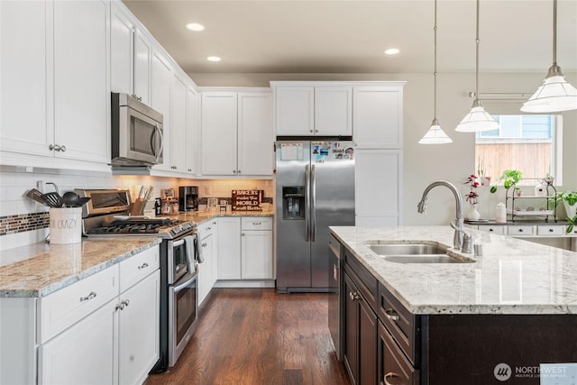 kitchen featuring white cabinetry, dark wood-style floors, appliances with stainless steel finishes, and a sink