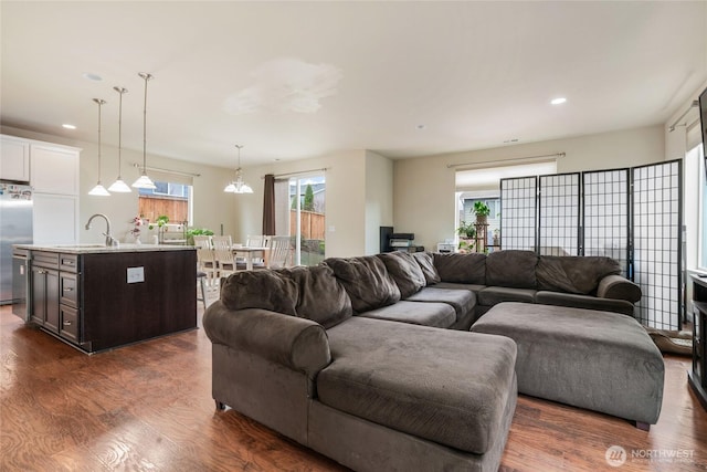 living area featuring dark wood-type flooring, recessed lighting, and a healthy amount of sunlight