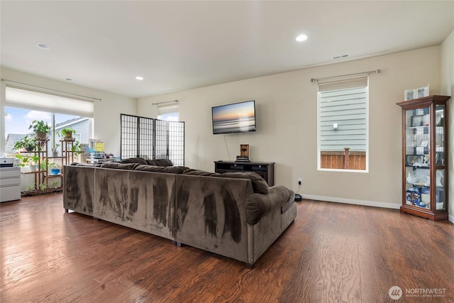 living room with dark wood finished floors, visible vents, recessed lighting, and baseboards