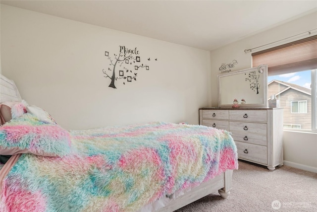 bedroom featuring light colored carpet and baseboards