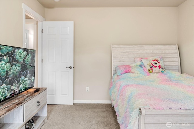 bedroom featuring light colored carpet and baseboards