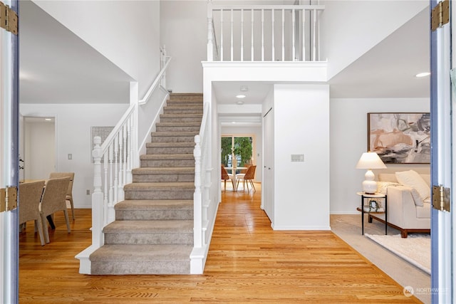 foyer featuring hardwood / wood-style flooring and a high ceiling