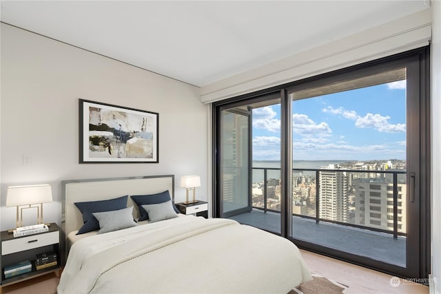 bedroom featuring a water view and access to outside