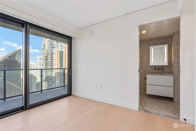 spare room with light hardwood / wood-style flooring