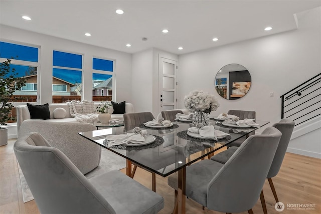 dining space featuring light wood-style floors, recessed lighting, stairway, and baseboards