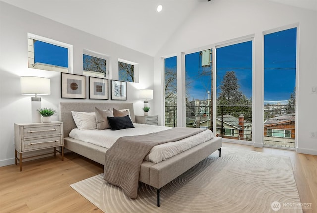 bedroom featuring lofted ceiling, recessed lighting, baseboards, access to exterior, and light wood-type flooring