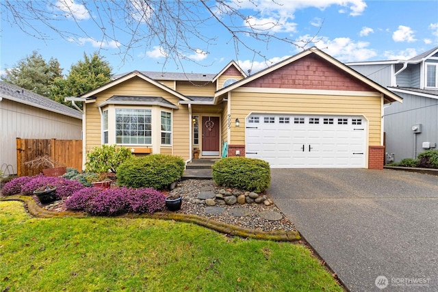 view of front facade featuring a garage, aphalt driveway, fence, and brick siding