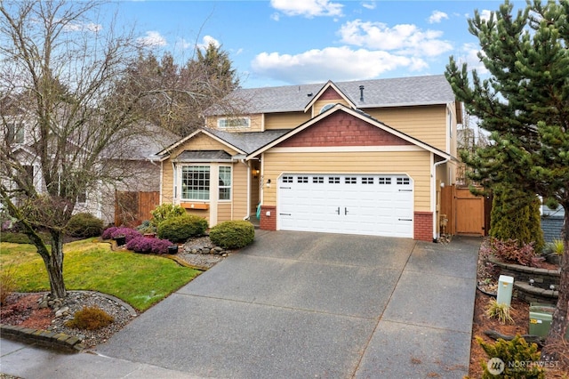 view of front of property featuring an attached garage, fence, concrete driveway, roof with shingles, and a gate