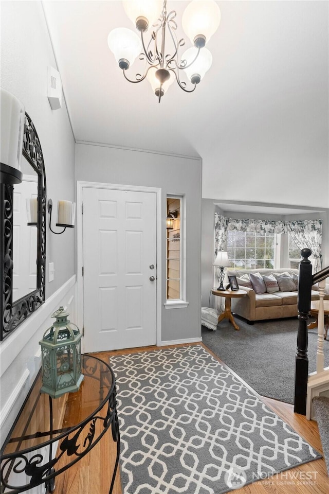 entryway with an inviting chandelier and wood finished floors