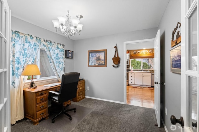 office space with a notable chandelier, baseboards, and carpet flooring