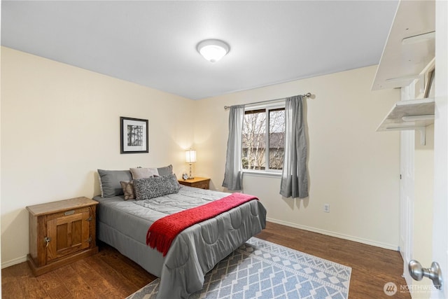 bedroom with wood finished floors and baseboards