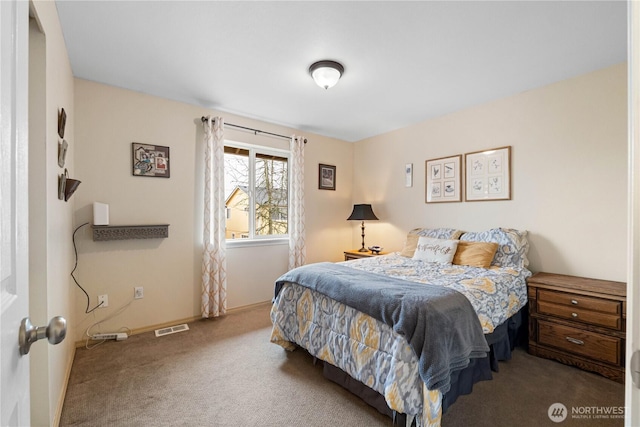 carpeted bedroom with visible vents and baseboards