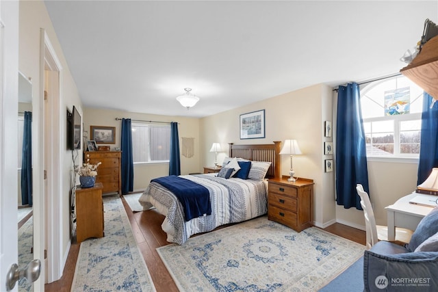 bedroom with baseboards and wood finished floors