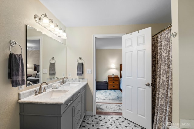 ensuite bathroom with a sink, double vanity, and ensuite bath